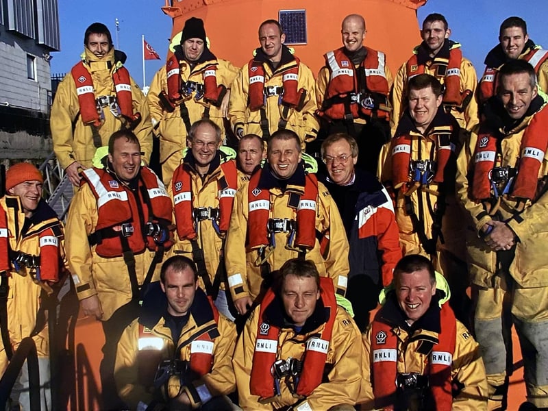 Newhaven Lifeboat crew of the ‘David and Elizabeth Acland', 2005. Featured top row, left to right: Joe Suttill, Norman Mayhew, Shaun Thomas, Rob Parker, Scott Parker, Chris Hamilton. Middle row, left to right: Keith Stevens (visiting Mechanic), Phill Corsi, Ian Johns (Coxswain), Lol Deakin. Robin Scott, Mike Tubb (Lifeboat Operations Manager), Chris O’Connor, Paul Legendre. Front row, left to right: Lee Blacknell, Robin Deakin and Nick Gentry.