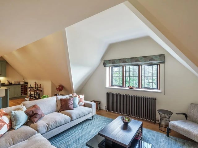 The open plan living room features large, original windows.