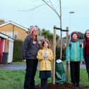 Isla Bezencon and her daughters Minnie and Freya pictured with Vicki Wells in front of their sponsored tree in Goring