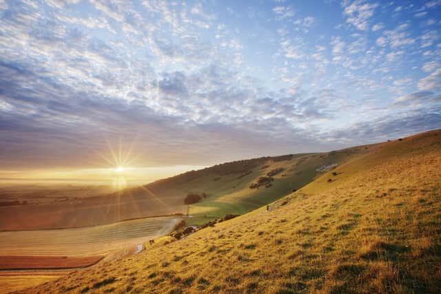 Sunrise over chalk downland viewed from Wilmington Hill, South Downs National Park. Photo by Guy Edwardes