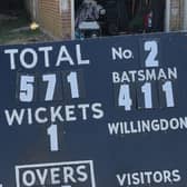 Ryan Welch next to the scoreboard showing his incredible knock for Willingdon