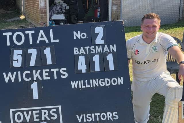 Ryan Welch next to the scoreboard showing his incredible knock for Willingdon