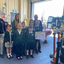 White Meadows School Council representatives present RNLI volunteers with monies they raised.