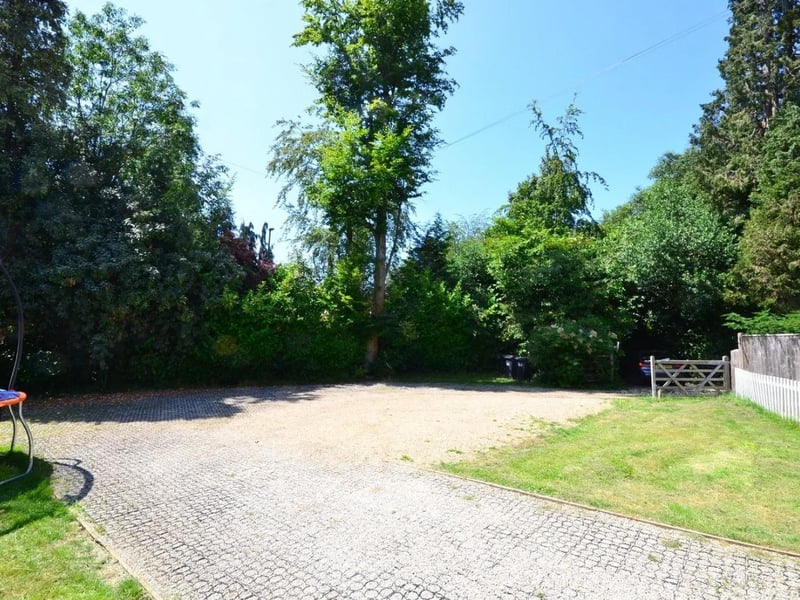 The home has gated driveway parking and a car port