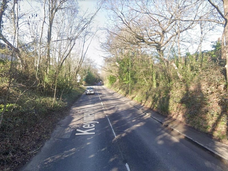 There is a pothole around a drain cover that is about four inches deep on Keymer Road in Hassocks near Station Approach West.
