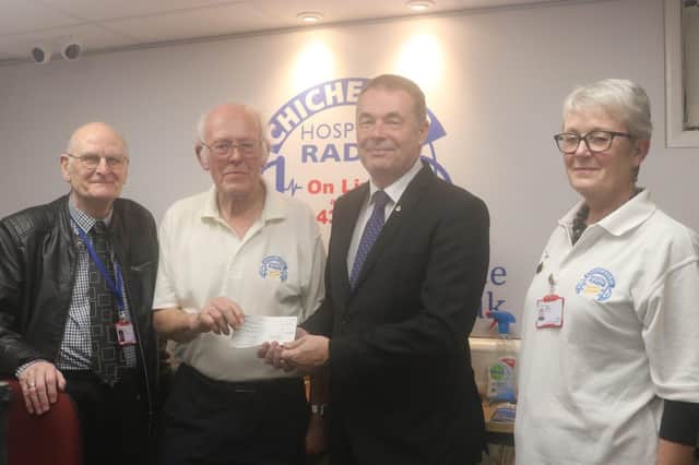 Chris Moore presenting cheque to Chris Blake of Chichester Hospital Radio.