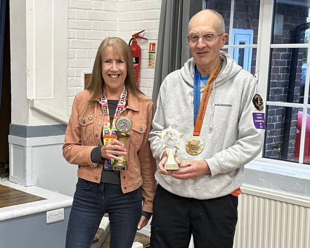 Tim and Nuala being presented trophies for their epic achievement | Submitted picture