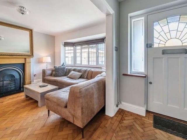 The welcoming hallway has a beautiful parquet floor