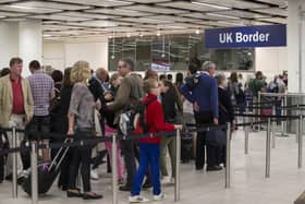Border Force check the passports of passengers arriving at Gatwick Airport  (Photo by Oli Scarff/Getty Images)