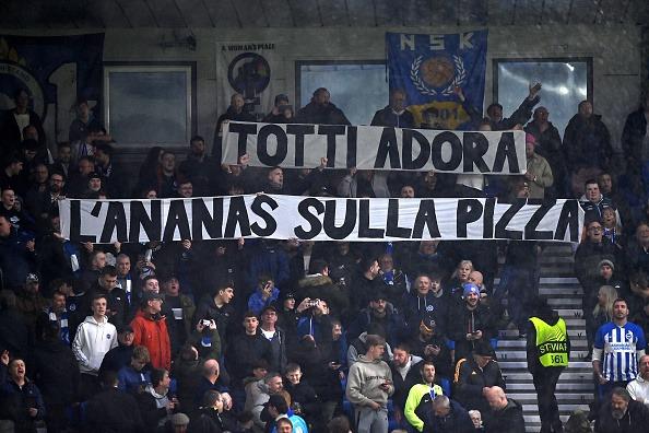 Brighton fans hold a banner ahead of the UEFA Europa League round of 16 second leg football match