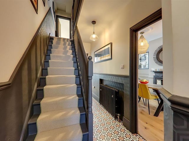 The entrance hall features mosaic tiled flooring