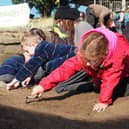 Children taking part in a dig.