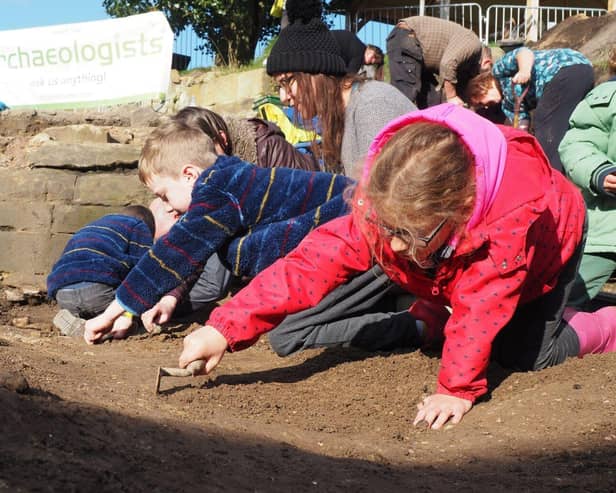Children taking part in a dig.