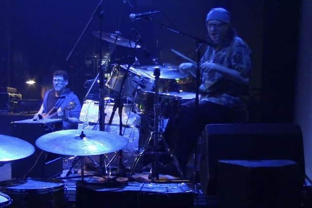 Phil performing on drums on stage