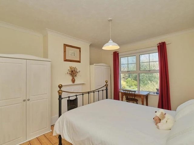 To the first floor there are four bedrooms, with the master room enjoying picturesque rooftop views and charming original cast iron fireplace.