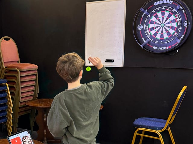 Participants hit 100,000 points playing darts. Mylo pictured playing darts.