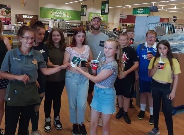 Children and leaders from The Sid Youth CIC collecting their £150 voucher from Morrisons Worthing community champion Joanne Easey