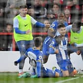 Facundo Buonanotte of Brighton & Hove Albion celebrates with teammates after scoring the team's first goal at Nottingham Forest