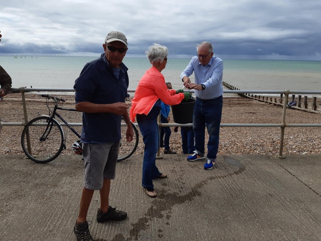 A bucket chain of volunteers from Ferring History Group and Ferring Conservation Group, including Worthing West MP Sir Peter Bottomley, form a bucket chain to bail out nine inches of water from the Ferring pillbox
