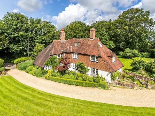The secluded property has a paddock, formal gardens, mature trees and a large lawned area
