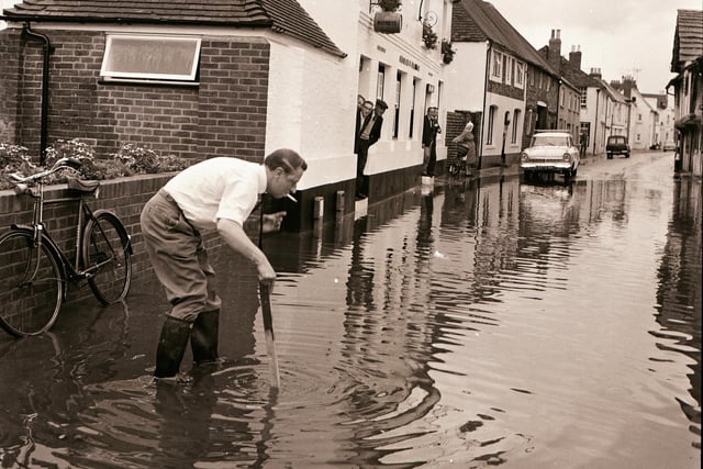 Measuring the depth of the flood water in Tarring High Street in September 1968