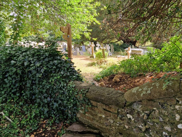 The walk ends in the churchyard, where there is a stone stile in the wall