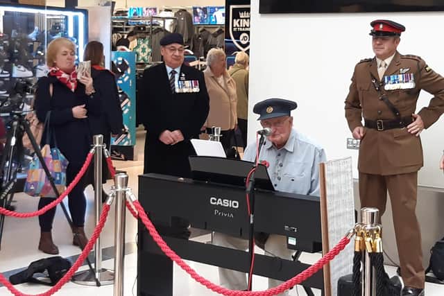 WATCH: Crawley shoppers stood in silence for Armistice Day and were treated to a performance from veteran pianist, Alan Woolven