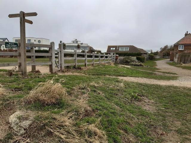 Walk through along the grass. You will pass three points of access to the Kingston Gorse Estate which are private and then this one which is public.