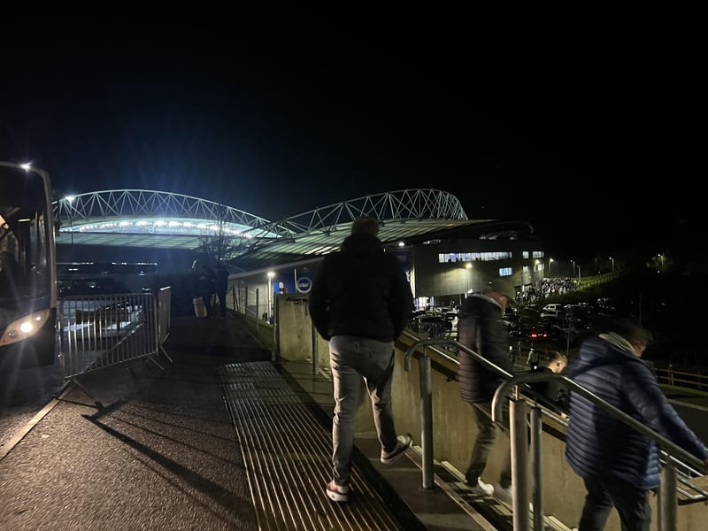 Fans getting off the bus to make their way down to the Amex Stadium.