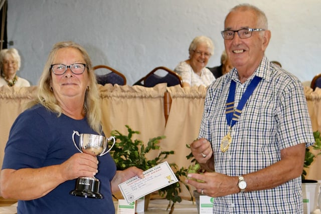 Liz Green is presented with the Floral Art Cup for most points from three shows