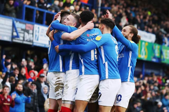The Pompey player mob George Hirst following his goal in today's win against Doncaster    Picture: Joe Pepler