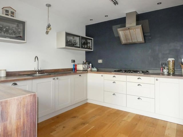 The kitchen features a range of integrated appliances
