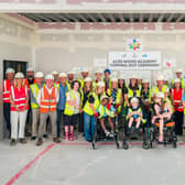 Contractors partners, pupils and their families celebrate the 'topping out' of Acre Wood Academy's new building. Photo: Horizon Imaging / Willmott Dixon Construction