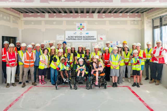 Contractors partners, pupils and their families celebrate the 'topping out' of Acre Wood Academy's new building. Photo: Horizon Imaging / Willmott Dixon Construction