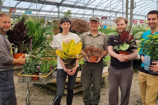 Budding Foundation founder Clive Gravett, centre, presents plants to a team from Shoreham charity Esteem at Mayberry Garden Centre in Portslade