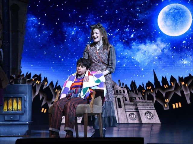 Charlie Bucket and his Mum in front of Wonka's factory
