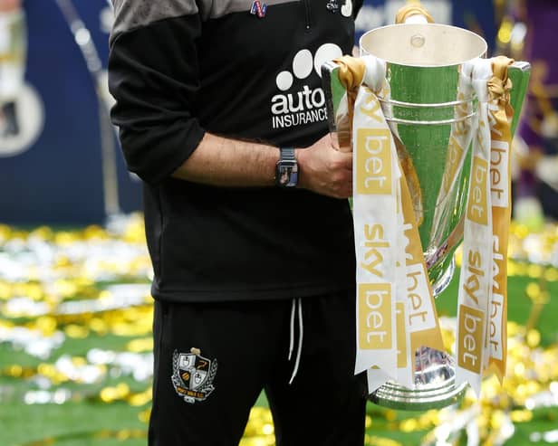 Darrell Clarke, Manager of Port Vale celebrates with the Sky Bet League Two Trophy (Photo by Eddie Keogh/Getty Images)