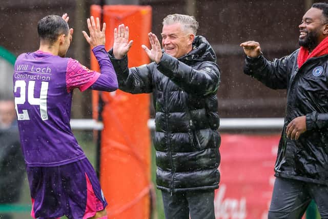 Players and management celebrate on the way to the Trophy win | Lydia Redman