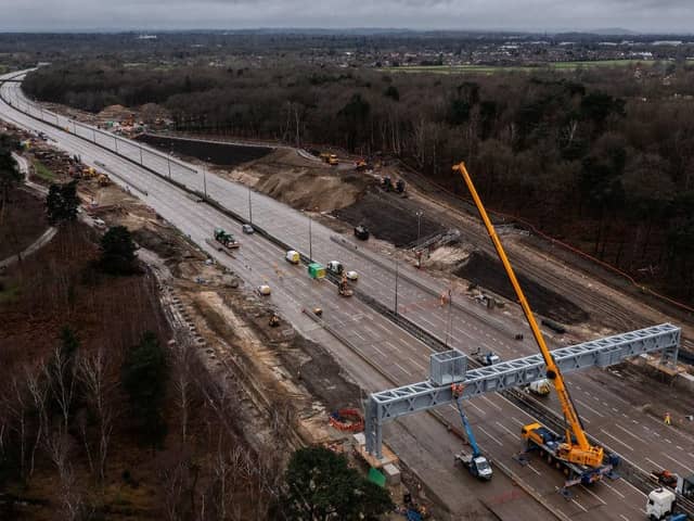 LONDON, ENGLAND - MARCH 17: In this aerial view a new gantry is installed over the M25 on March 17, 2024 in London, England. The full closure of a section of the M25 between junction 10 and 11 has taken place over the weekend to remove a bridge and install a new gantry. The closure is part of a £317m upgrade, with works expected to be finished by September. It is the first time there has been a scheduled daytime closure of all lanes of the motorway since it opened in 1986. The 117 mile long orbital motorway encircles Greater London and is the busiest in the UK. (Photo by Dan Kitwood/Getty Images)