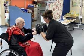 97 year old Army veteran Les Hollebone boxing with Rehabilitation Assistant Lisa