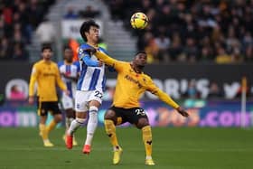 Nelson Semedo of Wolverhampton Wanderers battles for possession with Kaoru Mitoma of Brighton & Hove Albion during the Premier League match