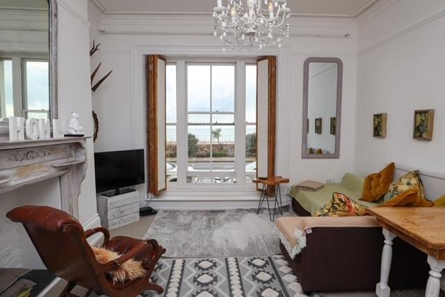 The lounge has floor to ceiling windows and overlooks the sea