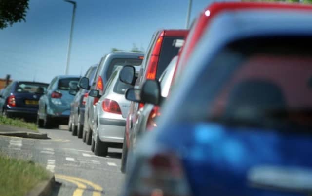 A rolled over car has closed a road outside Crawley