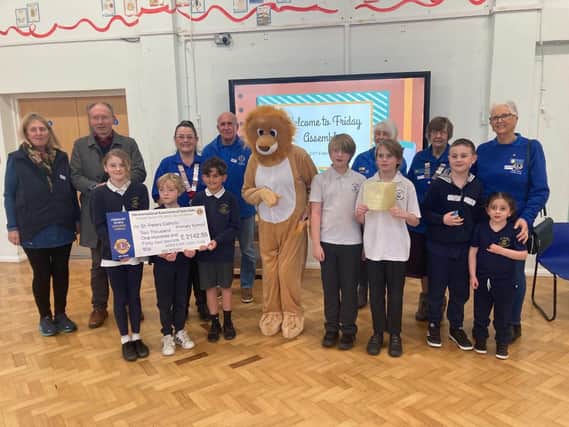 Adur East Lions presenting their cheque to children at St Peter's School
