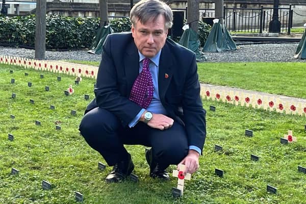 Henry Smith MP planting his wooden cross in the Constituency Garden of Remembrance in Parliament