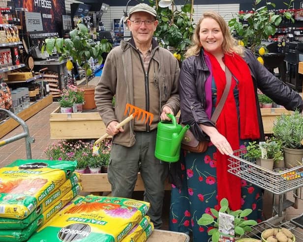 Clive Gravett from The Budding Foundation hands over the gardening goodies to Amy from Friends of We