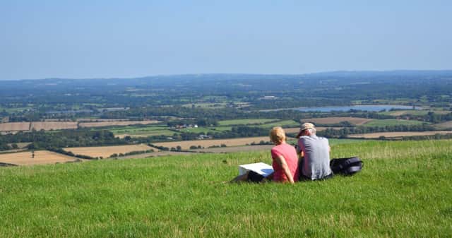 People sitting enjoying view from the South Downs East Sussex (Photo by Martin Charles Hatch)