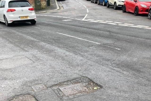 Pothole around a sunken drain cover in Harold Road