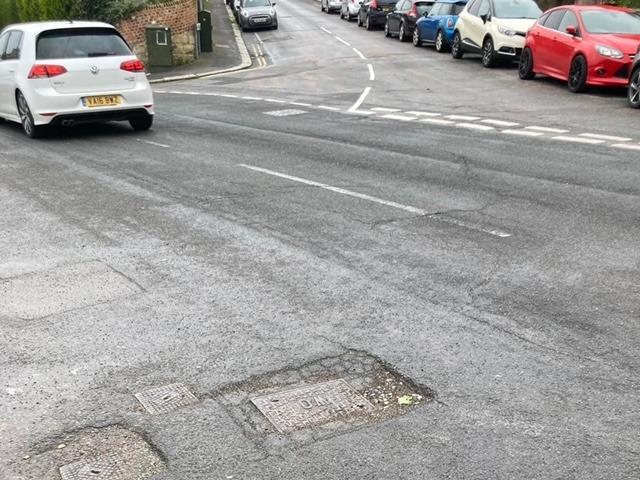 Pothole around a sunken drain cover in Harold Road
