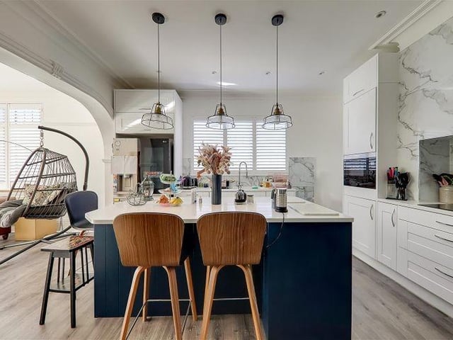 The luxury kitchen/breakfast room has a feature central island and integrated appliances